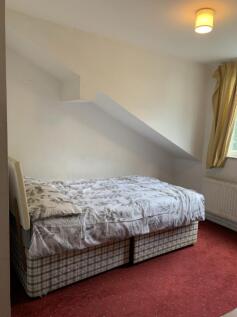 A cozy double bedroom with a comfortable bed an...