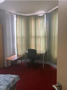 A cozy double bedroom with ample natural light ...