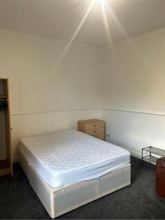 A comfortable double bedroom featuring a large ...