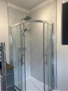 A clean and modern bathroom shower with frosted...