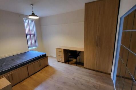 A bright and well-maintained bedroom featuring ...