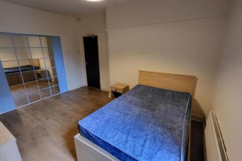 A cozy bedroom featuring a spacious layout with...