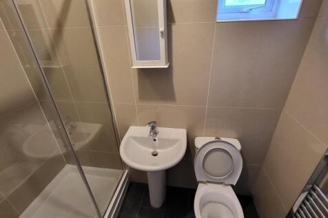 A modern bathroom featuring a sink, toilet, and...