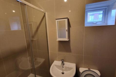 A clean and well-maintained bathroom with a sho...