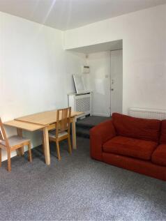 A cozy, simply furnished living room featuring ...