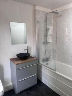 Modern bathroom featuring a spacious bathtub wi...