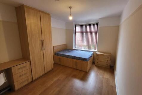 Bright and welcoming double bedroom featuring a...