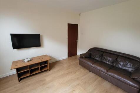 Spacious and well-lit living room featuring a l...