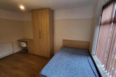 A small, tidy bathroom with a clean WC and mini...