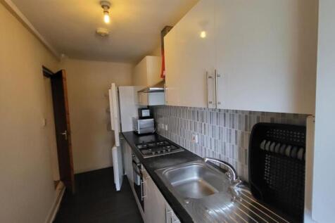 A compact, well-maintained kitchen featuring a ...