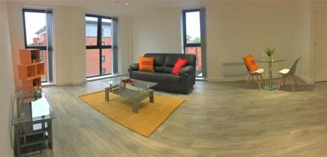 Spacious and modern living room with large wind...