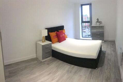 A stylish and spacious master bedroom featuring...