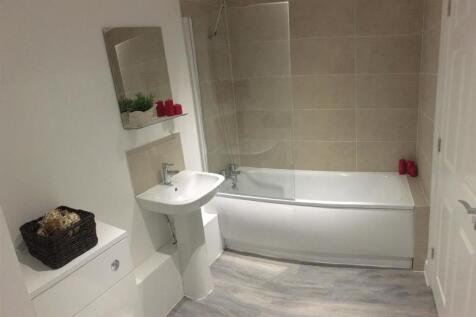 A modern and clean bathroom featuring a bathtub...