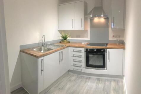 A modern, bright kitchen with sleek white cabin...