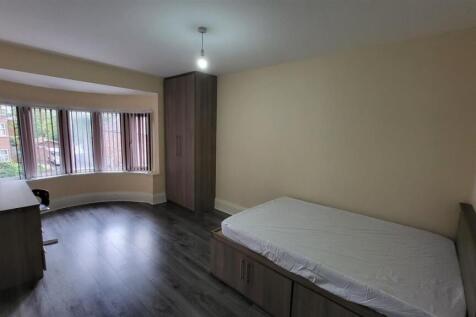 A well-maintained student bedroom featuring a s...