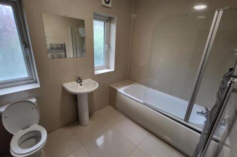 A clean and well-maintained bathroom with a bat...