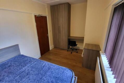 A well-maintained bedroom featuring a comfortab...