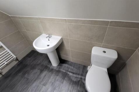 Modern bathroom with white pedestal sink, close...