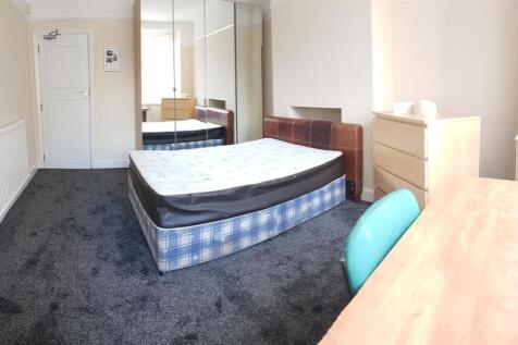 A bright and well-maintained bedroom featuring ...