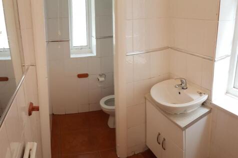 A clean and bright bathroom featuring a sink wi...