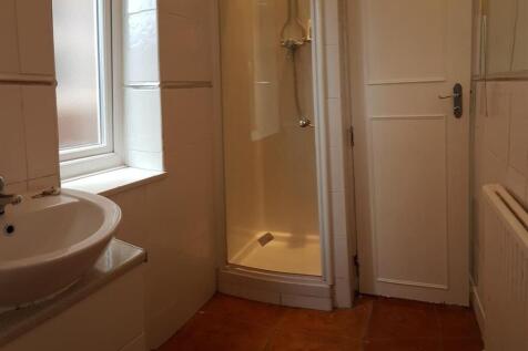 A clean and well-maintained bathroom with a sho...