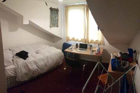 A cozy bedroom with a double bed, natural light...