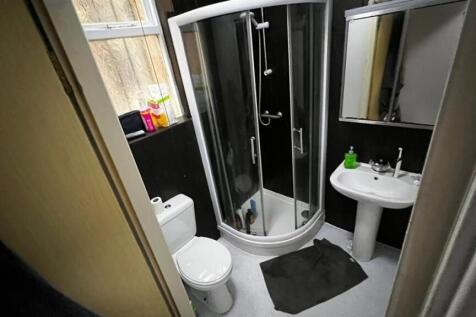 The bathroom features a spacious shower enclosu...