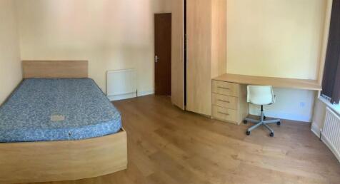 A tidy and well-maintained bedroom featuring a ...