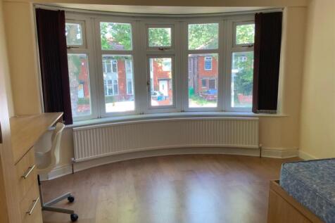 A bright and spacious living room with large wi...