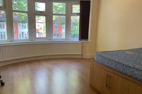 A bright and spacious living room with large wi...