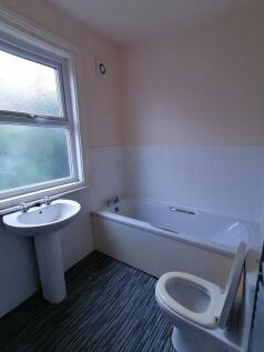 Bright, tidy bathroom with a full-size bathtub,...