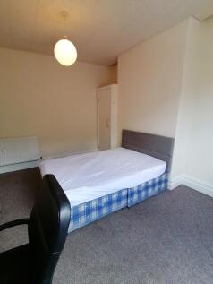 Simple furnished bedroom with a double bed on a...