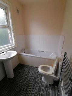 Bright, tidy bathroom with a full-size bathtub,...