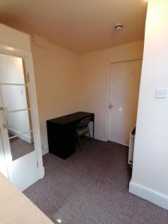 Simple, neutral communal workspace with a compa...