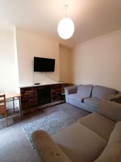 Bright, neutral living room with two comfortabl...