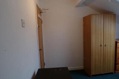 Compact furnished bedroom with a freestanding w...