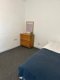 A cozy and well-maintained bedroom featuring a ...