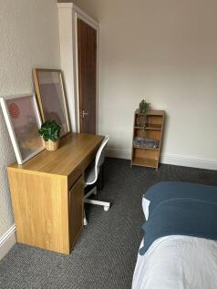 A tidy and well-organized bedroom corner featur...