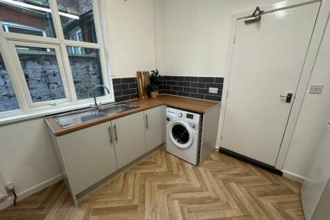 A bright, neatly maintained kitchen featuring a...