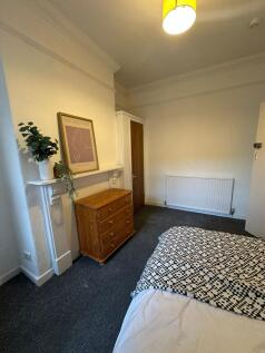 Bright and welcoming bedroom featuring a comfor...