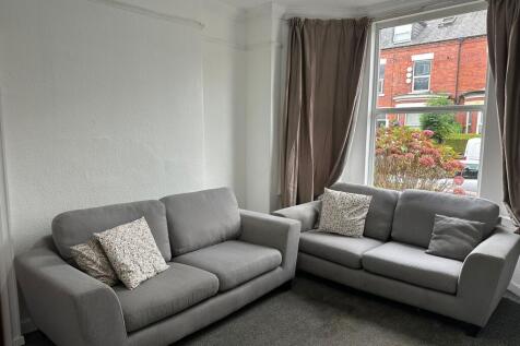 Bright and stylish living room filled with natu...