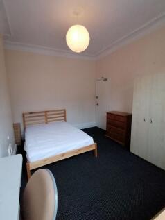 Bright, simply furnished double bedroom with a ...