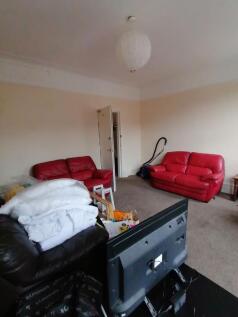 Spacious living room with high ceilings and two...