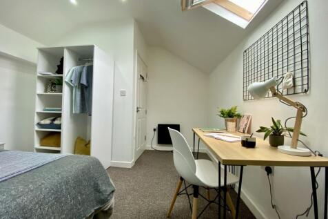 A spacious and bright double bedroom featuring ...