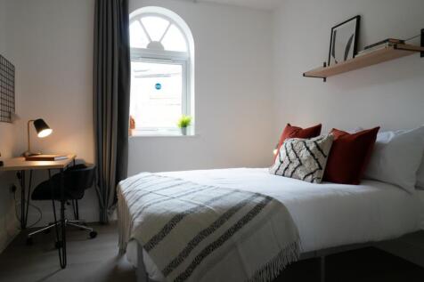 A bright and inviting double bedroom featuring ...