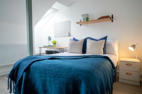 A bright and inviting double bedroom featuring ...