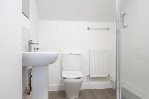 A modern and clean bathroom featuring a shower ...