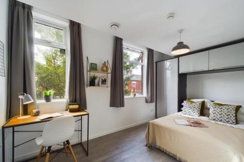 A bright and inviting double bedroom with a coz...