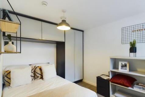 A modern and stylish double bedroom featuring a...
