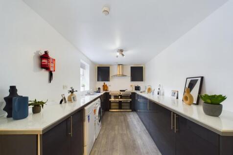 A spacious and modern kitchen with ample counte...